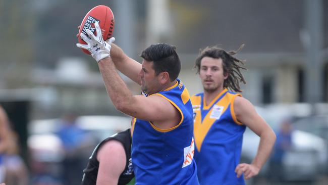 Marc Holt in a typical pose for Cranbourne — marking strongly.