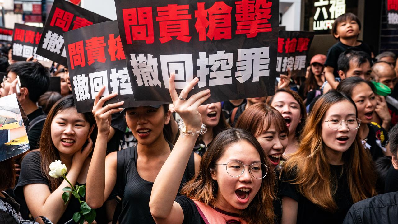 Protesters hold banners and shout slogans as they march in Hong Kong on June 16. Picture: Anthony Kwan