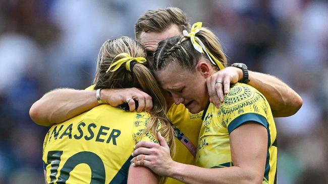 TOPSHOT - Australia's Maddison Levi (R) and Australia's Isabella Nasser (L) react after the women's semi-final rugby sevens match between Canada and Australia during the Paris 2024 Olympic Games at the Stade de France in Saint-Denis on July 30, 2024. (Photo by CARL DE SOUZA / AFP)