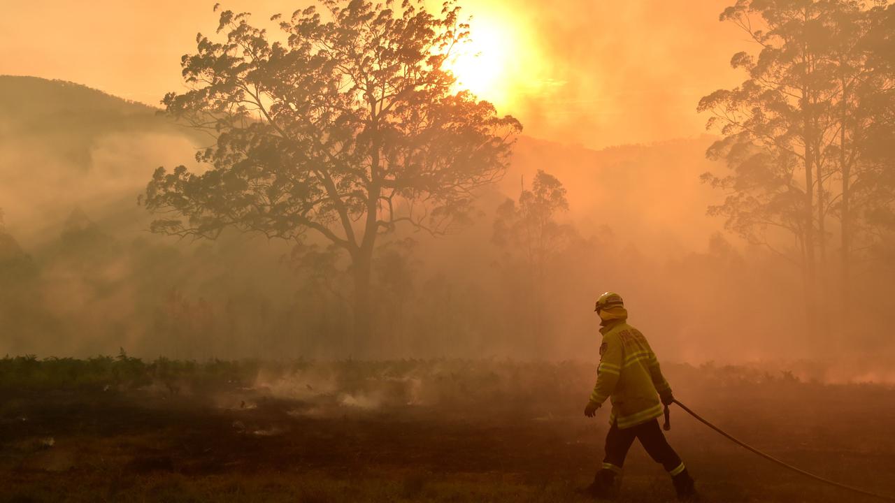 A firefighter surveys a bushfire at Hillville. Picture: AFP