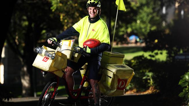 Australia Post delivery rider and Glenorchy football player, Aiden Grace is working hard during the COVID-19 pandemic. Picture: Zak Simmonds