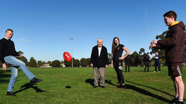 Federal Member for Casey Tony Smith kicks a short pass into the safe hands of Blake Hardwick as Len Cox and Eastern Devil's Kendra Heil look on. Picture: Steve Tanner