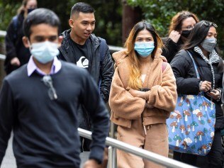 People wearing masks as they leave Central Station in Brisbane city.

Picture: Matthew Poon