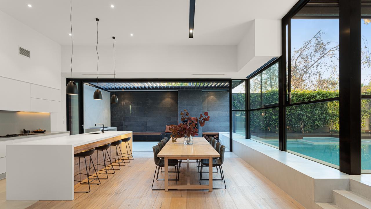 The kitchen and dining table looks right out to the pool.