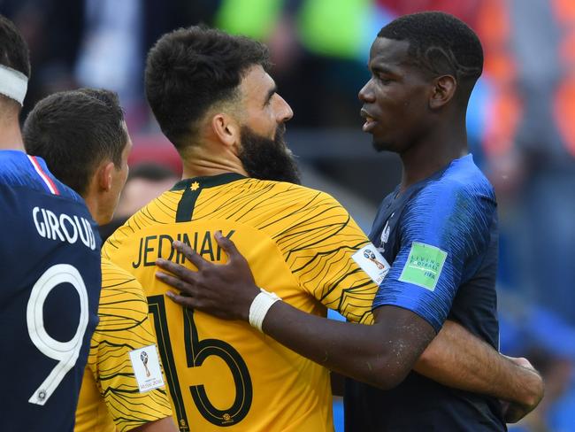 France star Paul Pogba (R) and Socceroos captain Mile Jedinak embrace following the opening Group C game. Pic: AFP