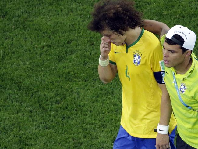 Brazil's David Luiz is consoled by teammate Thiago Silva as they walk off the pitch after the World Cup semifinal soccer match between Brazil and Germany at the Mineirao Stadium in Belo Horizonte, Brazil, Tuesday, July 8, 2014. Germany has routed host Brazil 7-1 and advanced to the final of the World Cup. (AP Photo/Felipe Dana, Pool)