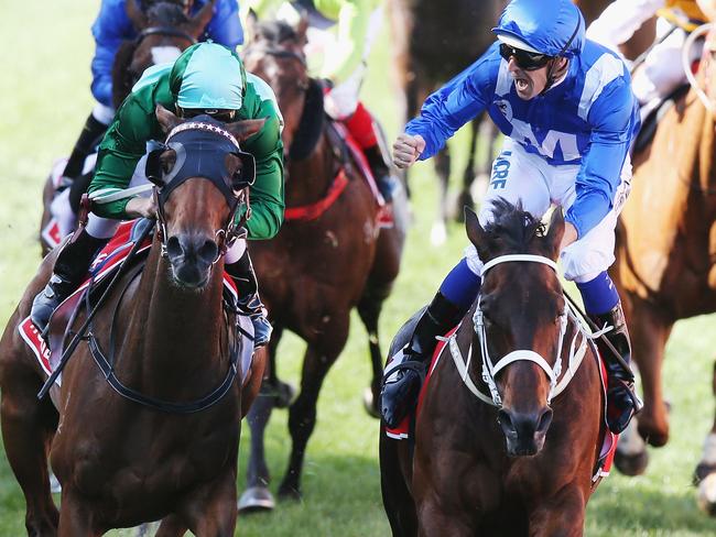 Hugh Bowman celebrates as Winx beats the fast-finishing Humidor (left) to make it three consecutive Cox Plates. Picture: Getty Images