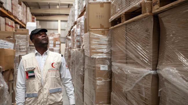 An Emirates Red Crescent volunteer checks humanitarian aid destined for Lebanon at the International Humanitarian City in Dubai. Picture: AFP