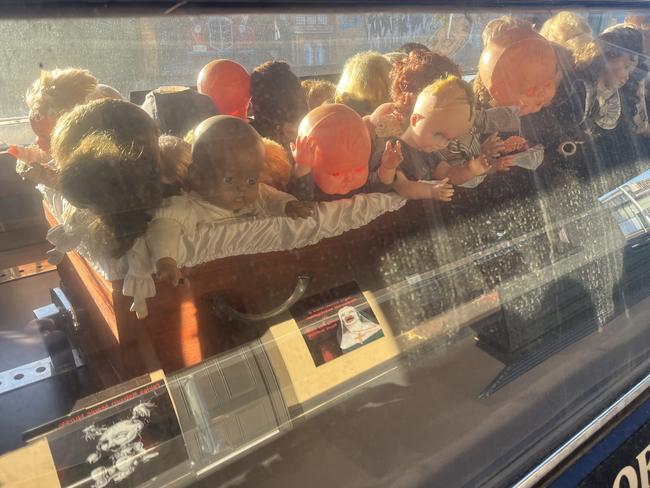 Dolls in the back of hearse outside the museum.