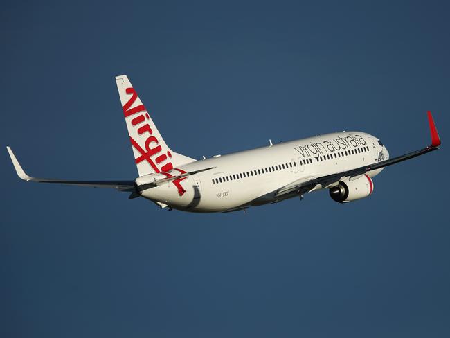 A Boeing Co. 737 aircraft operated by Virgin Australia Holdings Ltd. takes off from Sydney Airport in Sydney, Australia, on Thursday, Aug. 10, 2017. Virgin Australia said underlying performance for the first quarter of the 2018 financial year will improve from the year-earlier quarter. Photographer: Brendon Thorne/Bloomberg