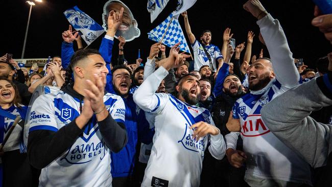 Bulldogs fans celebrate their teams win over the Dragons at Jubilee oval on Saturday night.Photo: Tom Parrish