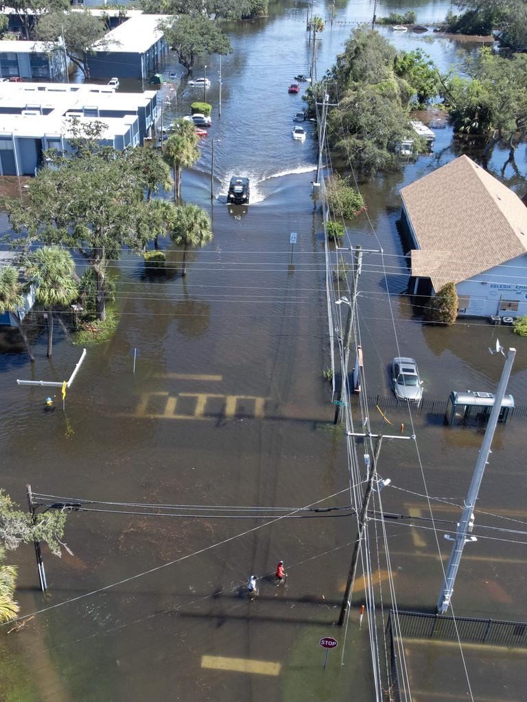 A drone image of a Sheriffâs Department vehicle moving through flooded streets in Tampa due to Hurricane Milton on October 10, 2024 in Florida. Hurricane Milton tore a coast-to-coast path of destruction across the US state of Florida, whipping up a spate of deadly tornadoes that left at least four people dead, but avoiding the catastrophic devastation officials had feared. (Photo by Bryan R. SMITH / AFP)