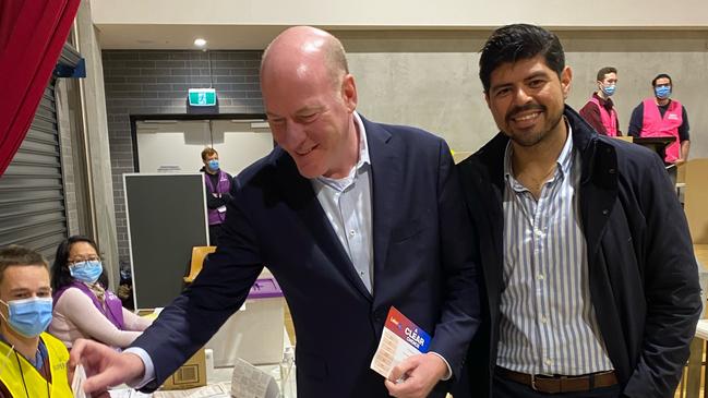 Trent Zimmerman casts his vote, pictured alongside partner Carlos Toledo.