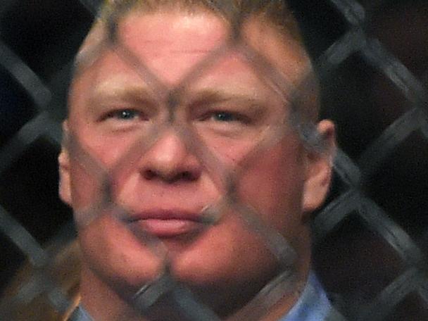 Former UFC heavyweight champion Brock Lesnar watches Ronda Rousey and Cat Zingano as they get ready to fight in a UFC 184 mixed martial arts bantamweight title bout, Saturday, Feb. 28, 2015, in Los Angeles. Rousey won after Zingano tapped out 14 seconds into the first round. (AP Photo/Mark J. Terrill)