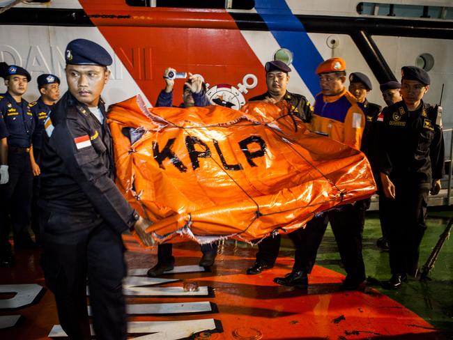 Indonesia Sea and Coast Guard carries remains of seats from the AirAsia flight at Port of Kumai on January 6. Photo by Oscar Siagian/Getty Images