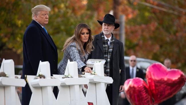US President Donald Trump and First Lady Melania Trump, alongside Rabbi Jeffrey Myers, pay their respects at the Tree of Life Synagogue following last weekend's shooting in Pittsburgh. Picture: AFP