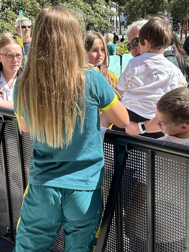 Ruby Trew autographs a baby in the crowd. Photo by Jamie Pandaram