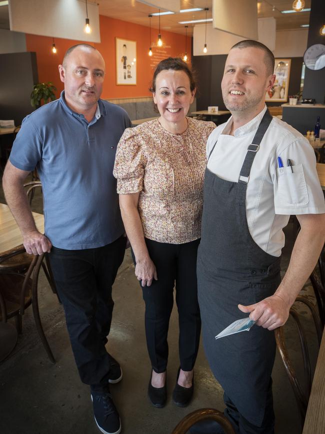 Spencer's Cafe new owners Ben Anderson (left) and Phil Coombe (right) with former owner Carly Martin at Lindisfarne. Picture: Chris Kidd