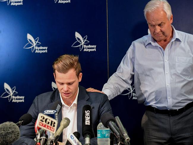 Steve Smith is comforted by his father Peter.