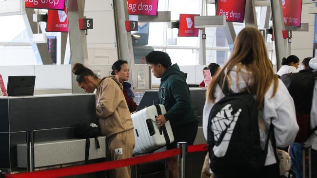 Long queues stretched out the door to the airport’s domestic departure’s terminal on Tuesday. Picture: Gaye Gerard