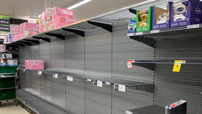 Empty shelves that were once stocked with toilet paper are seen in Balmain Woolworths, Sydney. Picture: AAP Image/Bianca De Marchi.