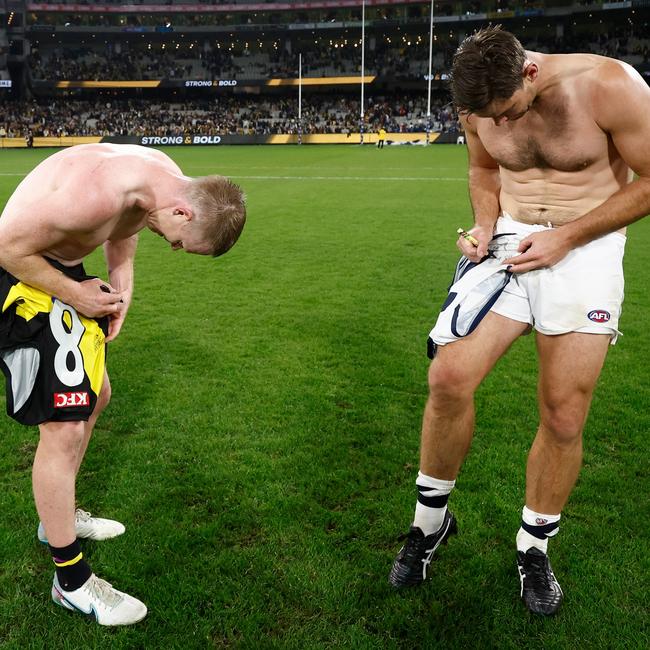 Jack Riewoldt and Tom Hawkins sign their jumpers post-match.