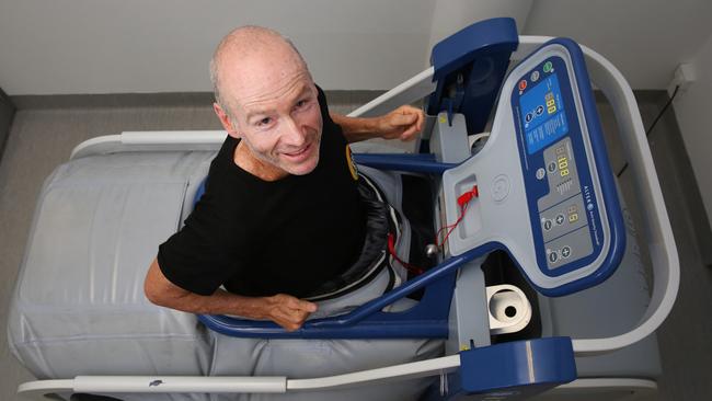 Ironman Paul Lemmon tests out the machine. (AAP Photo/Sue Graham)