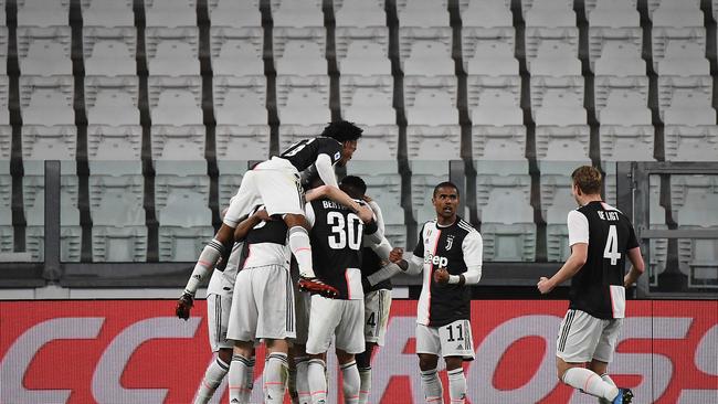 Juventus players celebrates after scoring their opener in front of no fans. Picture: Vincenzo Pinto/AFP.