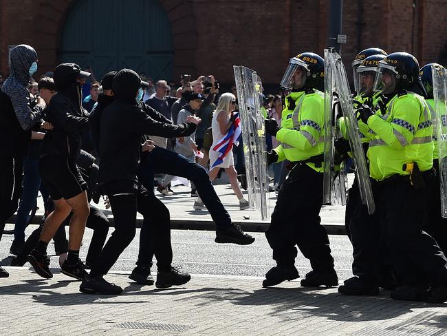 Police officers face protesters outside the Liver Building in Liverpool on August 3, 2024 during the 'Enough is Enough' demonstration. Picture: AFP.