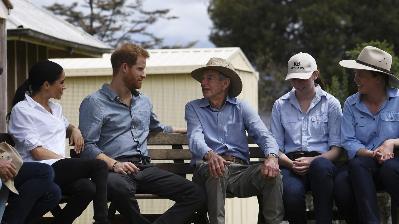 Prince Harry (second from the left) and his wife Meghan chat with farmers during a visit to the drought-affected farm Mountain View in Dubbo. Picture: Dean Lewins/AFP