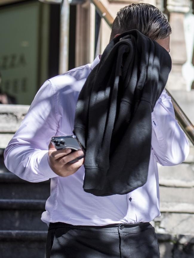 Campbell tried to hide his face as he left Downing Centre Local Court on Tuesday. Picture: Daily Telegraph / Monique Harmer