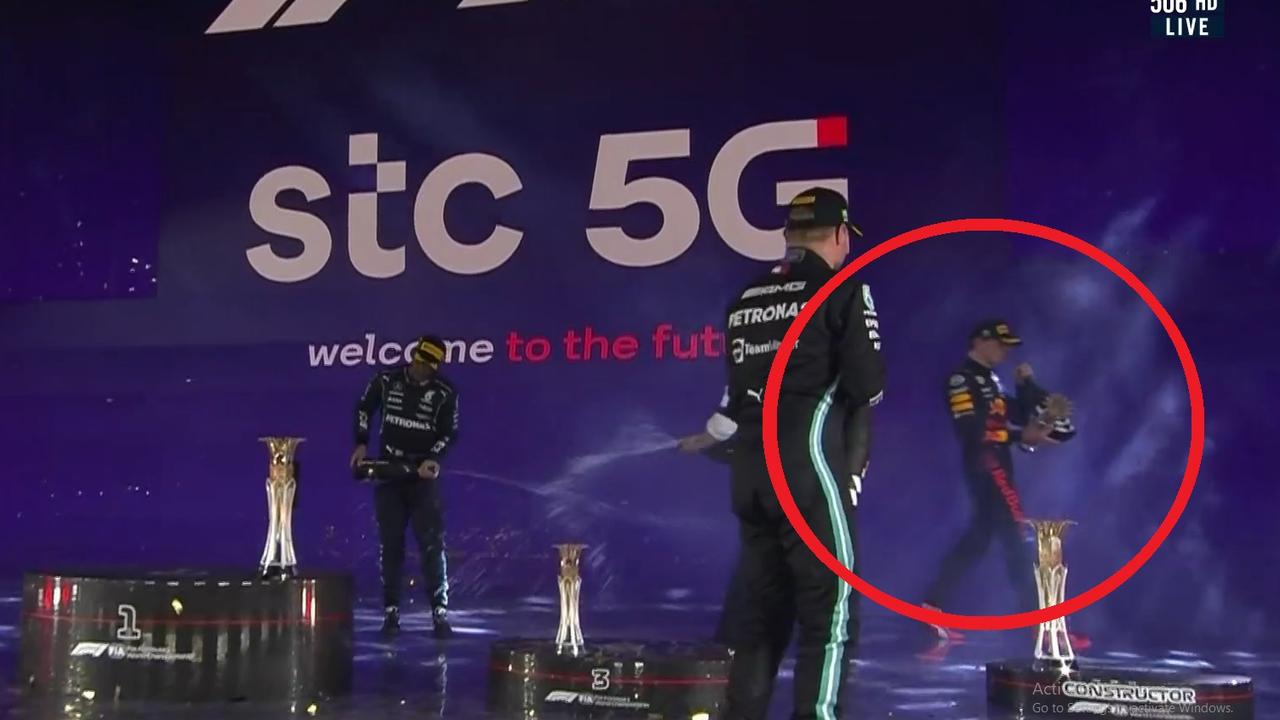 Lewis Hamilton celebrates as Max Verstappen walks. Photo: Kayo.