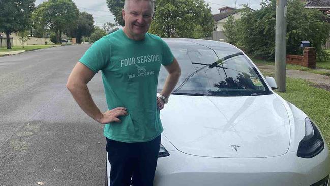 Chris Bowen with his Tesla Model 3, when he became the third federal Labor MP to go electric.