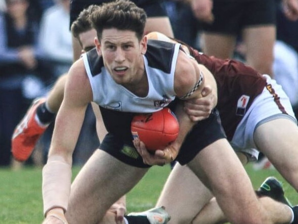 Ringwood captain Trent Farmer is caught in a tackle in the Eastern Football League (EFL). Picture: Davis Harrigan