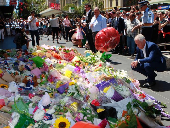 Prime Minister Malcolm Turnbull lays flowers at the memorial site for the Bourke St tragedy. Picture: David Crosling