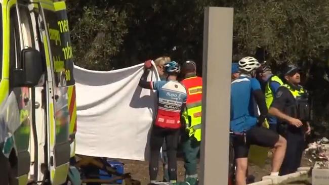 Other cyclists help paramedics after the fall. Picture: 7NEWS