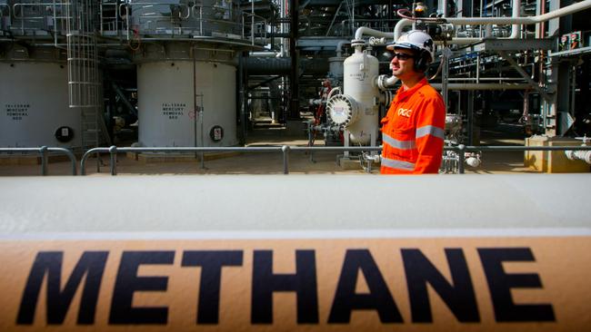 A worker walks past a gas pipe marked "Methane" at the Curtis Island liquefied natural gas (LNG) plant, a part of the Queensland Curtis Liquefied Natural Gas (QCLNG) project site. Photo: Patrick Hamilton