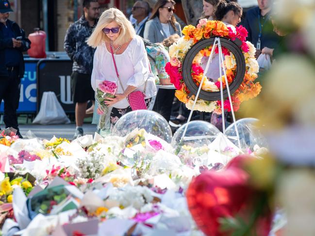 People return to Bondi junction Westfields to bring flowers and show their respect. Picture Thomas Lisson