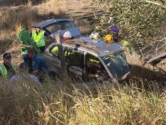 Driver trapped after car rolls over embankment