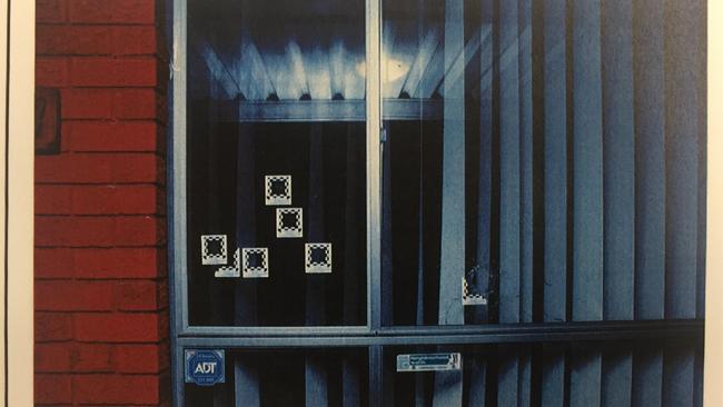 Police photographs show bulletholes in a window at the home of Michael Odisho at Reilley Street, Winston Hills. This was tendered at the 2016 Brothers For Life gangland trial.