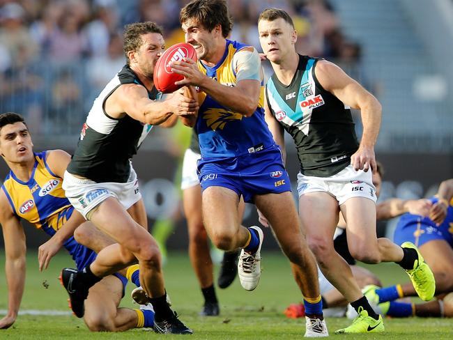 Andrew Gaff of the Eagles looks to break a tackle by Travis Boak of the Power.