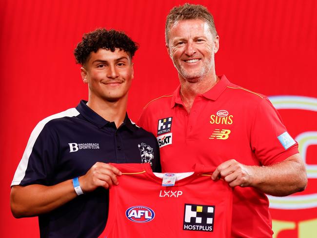 MELBOURNE, AUSTRALIA - NOVEMBER 20: Jake Rogers is seen with Damien Hardwick, Senior Coach of the Suns after being selected at number 14 during the 2023 AFL Draft at Marvel Stadium on November 20, 2023 in Melbourne, Australia. (Photo by Michael Willson/AFL Photos via Getty Images)