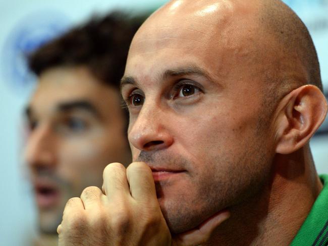 Australian national soccer team Socceroos player Mark Bresciano (R) looks on as midfielder Mile Jedinak (L) speaks at a press conference in Gosford on May 21, 2014. Crystal Palace midfielder Mile Jedinak was named captain of Australia's World Cup squad following the axing of Lucas Neill. AFP PHOTO / Saeed KHAN --IMAGE RESTRICTED TO EDITORIAL USE - STRICTLY NO COMMERCIAL USE--