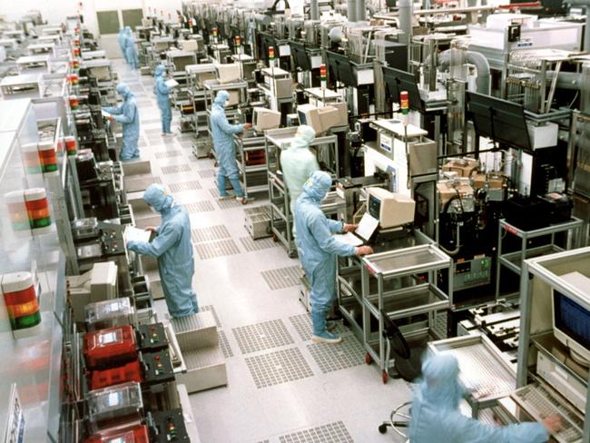 Workers are seen in full PPE at the Taiwan Semiconductor Manufacturing factory in October.