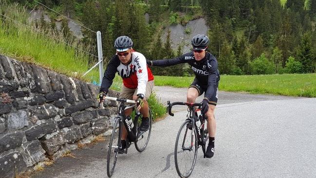 Cadel Evans helps a member of the media group up a climb in Switzerland. Picture: Supplied.