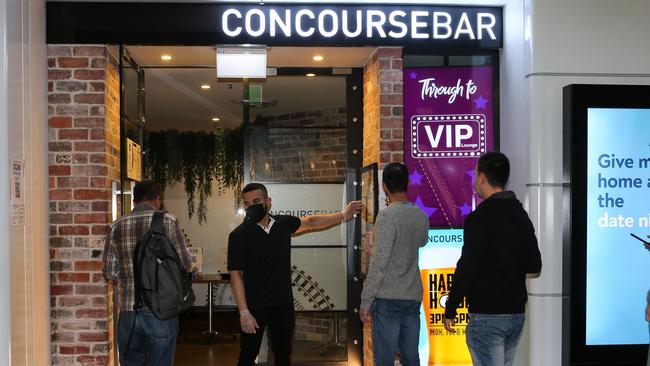 Staff at the Concourse Bar checking people in with QR codes as it reopens for business after the fight. Picture: Gaye Gerard