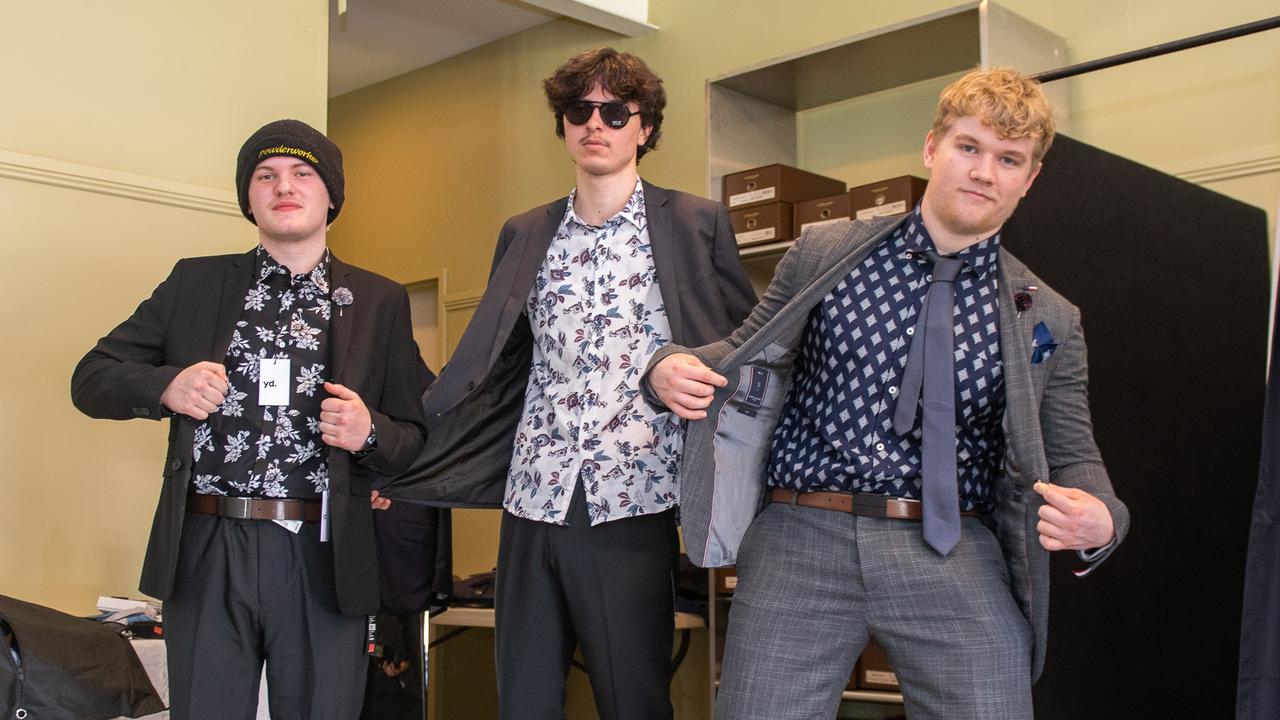 Left: Luke Walker, Tahlo Nicholson-Moss, and Connor McDougall being fitted for their year 12 formal suits at the Lismore Showgrounds.