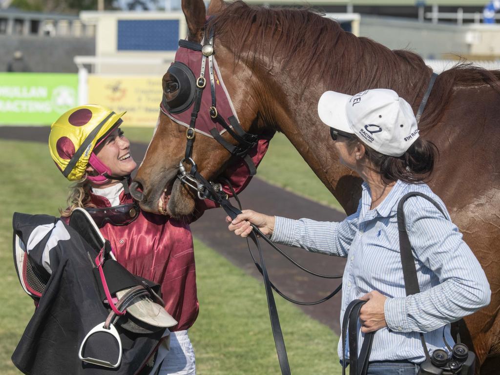 Jockey Laura Cheshire and trainer Joanne Hardy give Real Time Warrior a pat after he won a race.