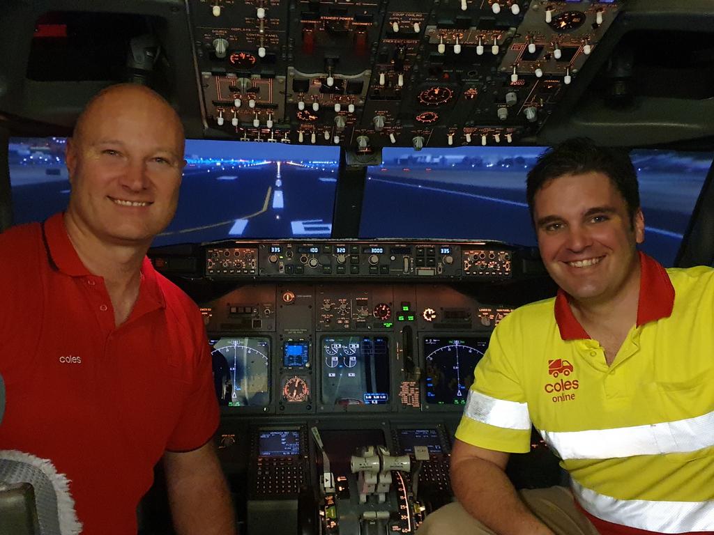 Virgin Australia pilots and Coles team members Danny Zilovic and Mitch Dean in a Boeing 737-800 flight simulator. Picture: Supplied