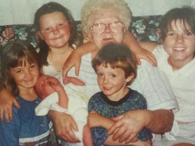 Karlie (far left, blue top) as a child with her grandmother Connie Duffy and cousins.